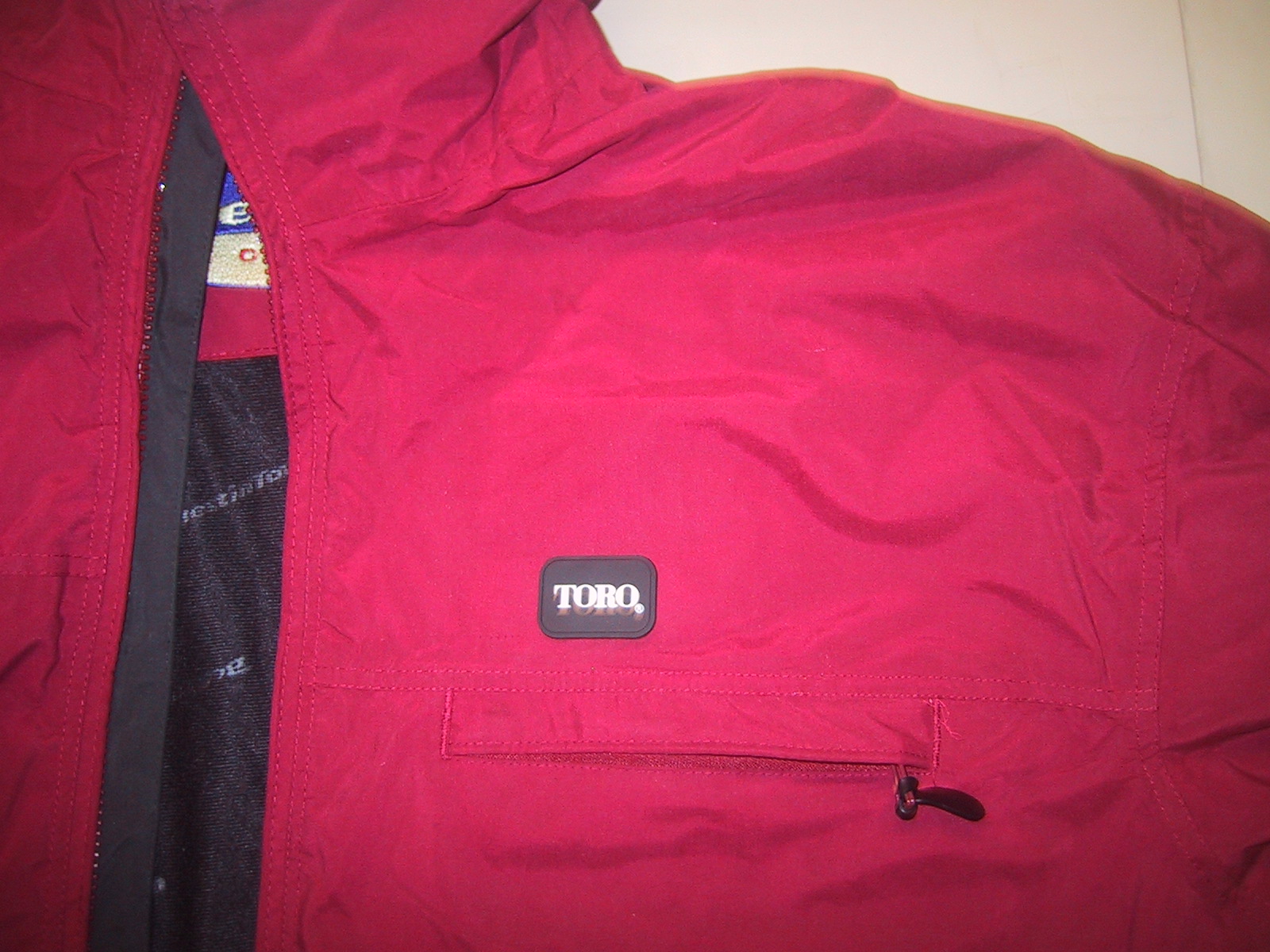 Rubber badge sewn-on to jacket cap re-labelling and patch